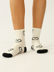 white socks with copy space on human foot close up photo on white background