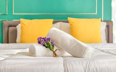White towels on the bed to welcome new guests in a luxury hotel at a seaside resort