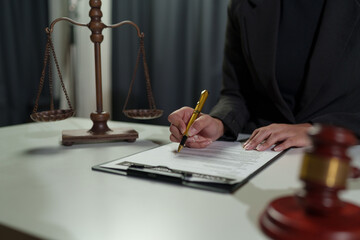 Lawyer women holding pen with contract or agreement document to the customer for signing in...