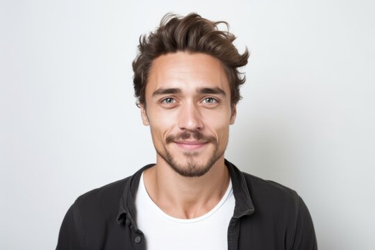 Portrait of a handsome young man with a beard on a white background