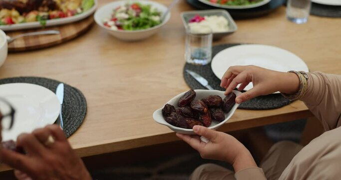 Ramadan kareem, hands or family with dates for breaking fast, eid or sacred tradition before eating together closeup. Food, nutrition or fruit for people fasting, Mubarak or Islamic celebration