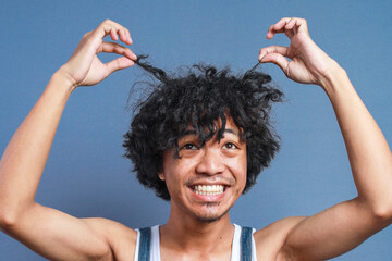 Funny Young Curly Man Pull Hair Up While Looking Up