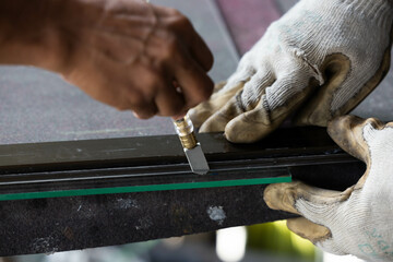 Technicians are using cutting tools, cut glass according to customer size