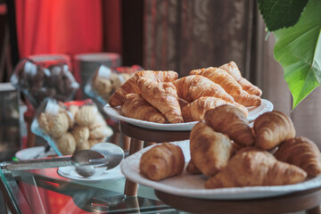 many croissants in many trays awaited to be served to the business conference attendees during the...