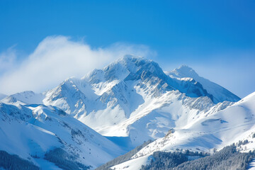 view of a snowy mountain peak with a blue sky - obrazy, fototapety, plakaty