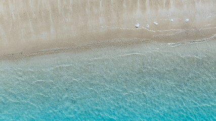 The soft wave water of the sea on the sandy beach background
