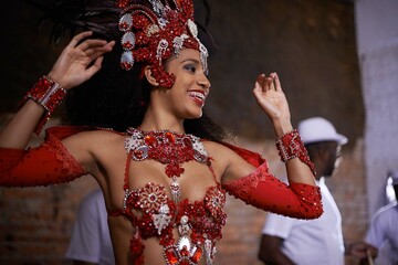 Happy woman, samba dancer and performance with costume for tradition at carnival or festival. Face of female person or exotic performer with band for culture or dancing at party or concert in Rio