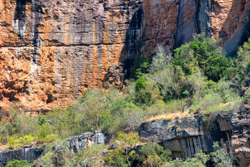 Rugged scenery in Outback Australia, with red dust plains, dramatic rock formations, and vast, open...