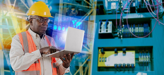 Engineer african american man working with laptop computer and digital technology security control and sustainable resource environment technology interface IOT.