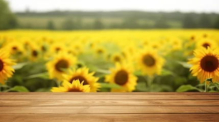 Foto op Plexiglas Empty Wooden Tabletop Desk Plank for Product Display with Blurred Background of Sunflower Field © RBGallery