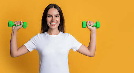 Fitness gym. Strong sporty sportswoman. Woman do sport training exercise isolated on yellow....