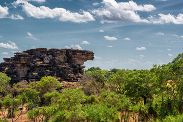 Rugged scenery in Outback Australia, with red dust plains, dramatic rock formations, and vast, open...