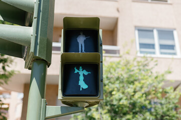 Naklejka premium green traffic signal with a human figure during April Fair in Seville, Spain Andalusia