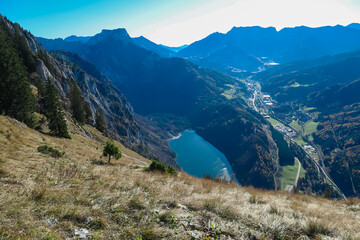 Panoramic aerial view of alpine lake Leopoldsteinersee in Eisenerz, Styria, Austria. Looking at majestic mountain peaks of Eisenerzer massif. Wanderlust in remote Austrian Alps. Idyllic hiking trail