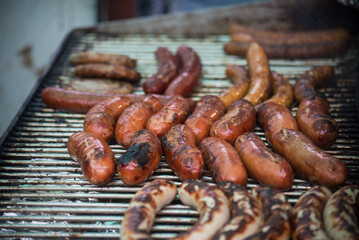 closeup of sausages on the barbecue in the street - 743450027