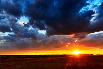 red sunset with clouds after rain in the steppe