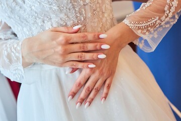 Hands of the bride in a wedding dress close-up. A wedding or engagement.