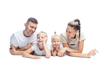 Happy family with children lying on their stomach. Mom, dad, daughter and son in white T-shirts hug and laugh. Love and tenderness. Isolated on a white background.