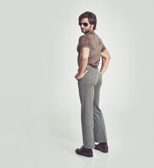 Man, retro and confident in studio for vintage fashion, sunglasses and unique trendy clothes for...