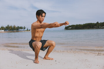 Fototapeta na wymiar Active Asian Athlete Running on the Beach: A Muscular Man enjoying Fitness and Freedom in a Summer Workout