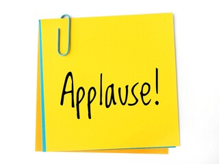Applause! handwritting message on a yellow sticky note
