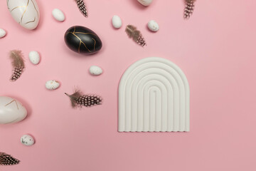 Top view of easter eggs, feathers on pink background. White arch tray, product presentation. Creative easter composition, spring, flat lay, copy space.