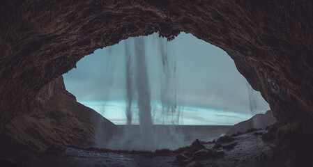 Beautiful view of Seljalandsfoss in Iceland on summer morning. View behind the water curtain of the...