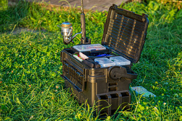 A large fisherman's tackle box fully stocked with lures and gear for fishing.fishing lures and...