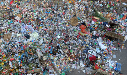 Cleaning workers are working on the piles of garbage with health risks.