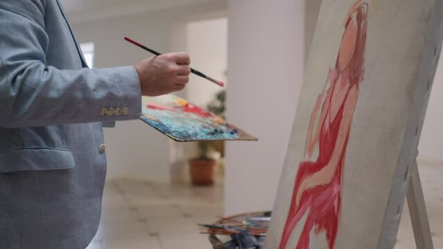 Painter draws woman of dreams on canvas
