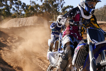 People, race and professional motorcyclist with dirt bike for extreme sports or outdoor competition. Expert rider, friends or team on motorbike, training or sand course for off road rally challenge