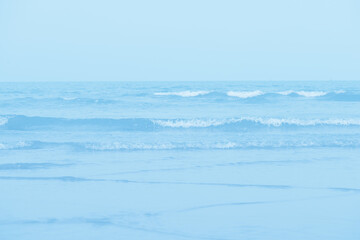 Waves on the beach. Blue sea wave. Blue water surface texture with ripples, splashes, and bubbles....