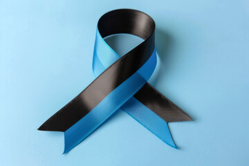 Dual-Colored Black and Blue Awareness Ribbon on Light Blue Background