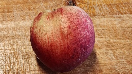 a peach on the cutting board
