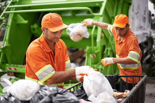 Men, garbage truck and plastic collection as service for city pollution on sidewalk for cleaning, environment or waste management. Teamwork, recycling and trash transportation, junk or sanitation