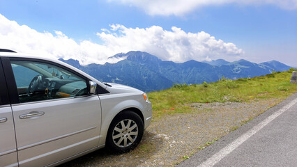 Traveling by car along mountain roads. The car is standing on the edge of a cliff. Magnificent...