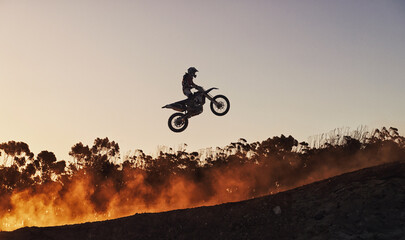 Person, jump and professional motorcyclist in the air on mockup for trick, stunt or ramp on outdoor dirt track. Expert rider on motorbike with lift off for extreme sports or rally challenge in nature