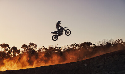 Person, jump and professional motorcyclist in the air on mockup for trick, stunt or ramp on outdoor...
