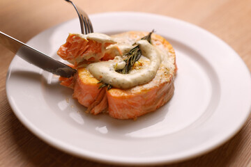 Baked salmon steak with sauce is delicious. Red fish dish.