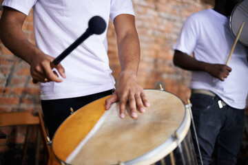 Fototapeta na wymiar Hands, drum or carnival with a person playing an instrument in a festival in Rio de Janeiro, Brazil. Closeup, band or party with a musician, performer or artist banging to create a beat or rhythm