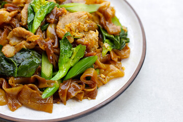 Stir-fried rice noodles with soy sauce and pork