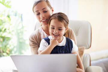 Laptop, education or elearning with woman and daughter on sofa in living room of home to study...