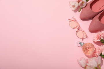 Flowers, female perfume, glasses and shoes on pink background, space for text