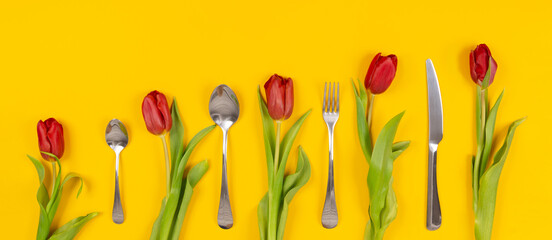 Holiday card. Food delivery. Red tulips with cutlery on yellow background. Dinner invitation on international woman day March 8th. Banner with copy space. Cleaning service certificate. Clean kitchen.