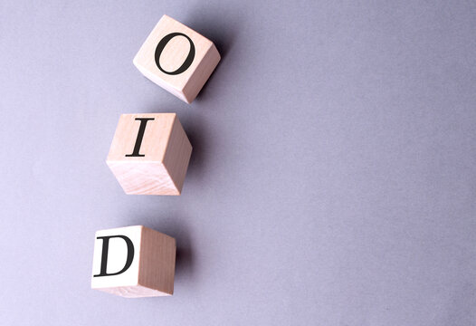 Word OID on wooden block on the grey background