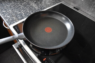 Teflon pans on the induction hob in the kitchen