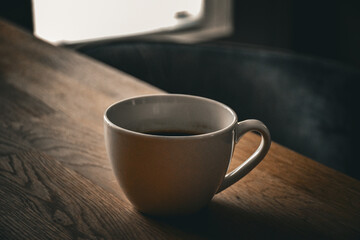 ceramic cup of hot coffee on the table