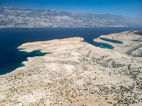 Pag Island coastline with some boats in the coves near Jadra Beach, Stara Novalja and Zigljen, Croatia and the beautiful blue Adriatic sea