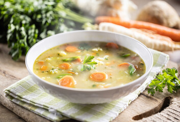 Spring vegetable soup with chopped and grated root vegetables, seasoned with yeast. Healthy...