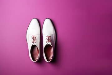 White Dress Shoes on Pink Background. Elegant white dress shoes on vibrant pink backdrop, representing style and sophistication.